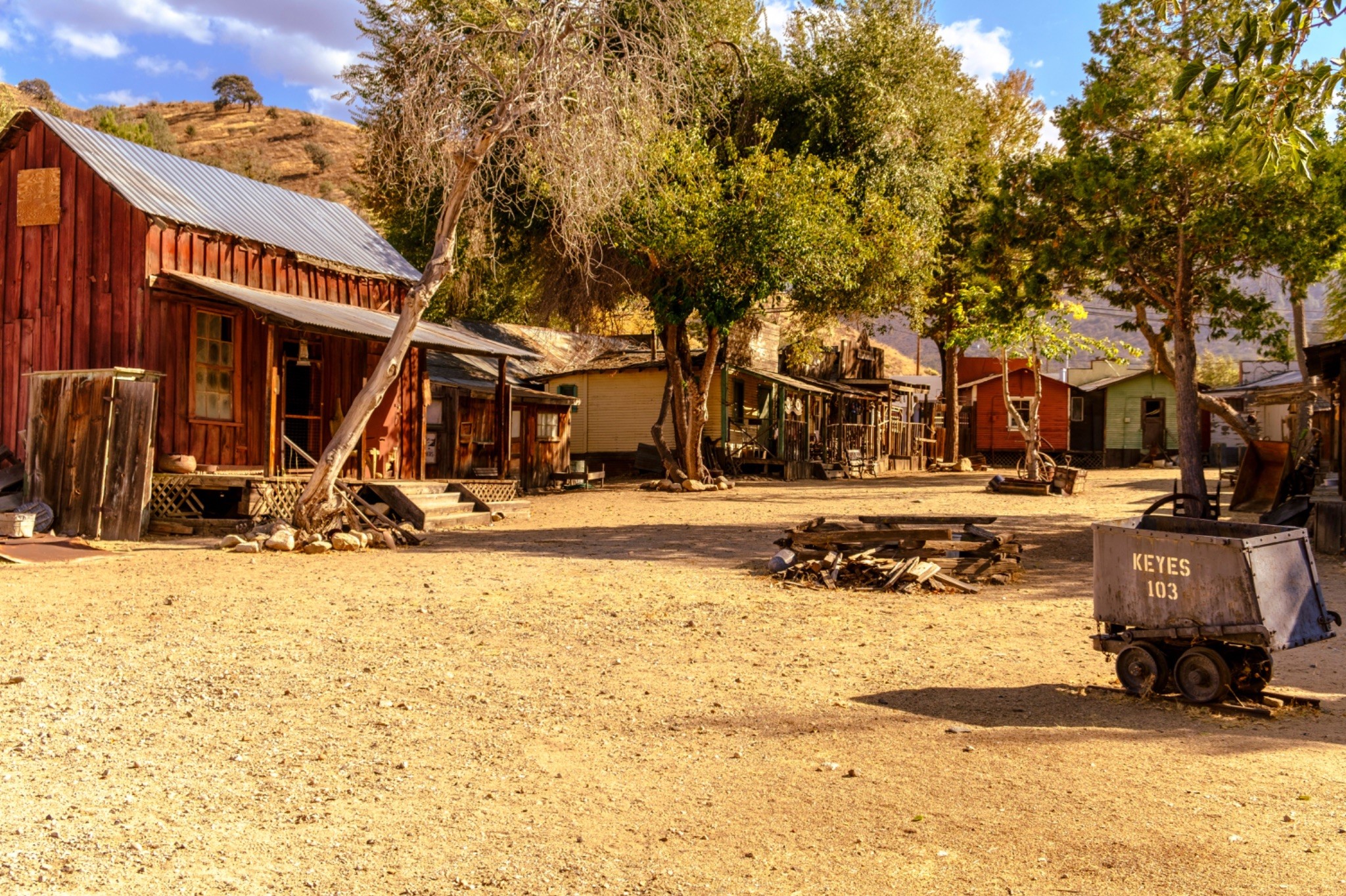 Jean Archambault- White_Month 6 B Historic frontier towns with wooden buildings and dirt roads.