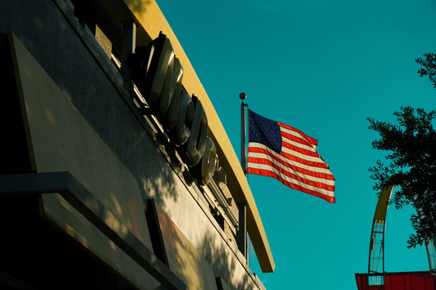 A United States flag waves symbolizing modern America.